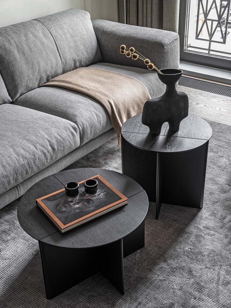 A variety of grey and black tones, as well as the combination of textures create layering to achieve a sense of depth.