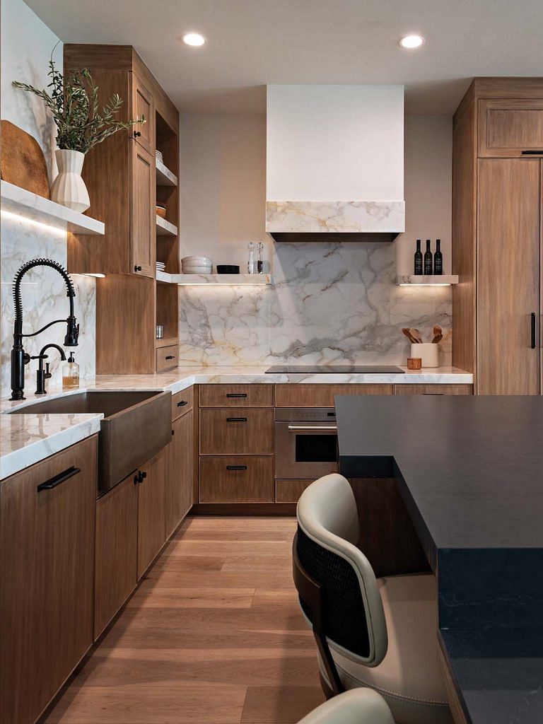 The matching marble backsplash and countertop adds a luxurious feel to the kitchen.