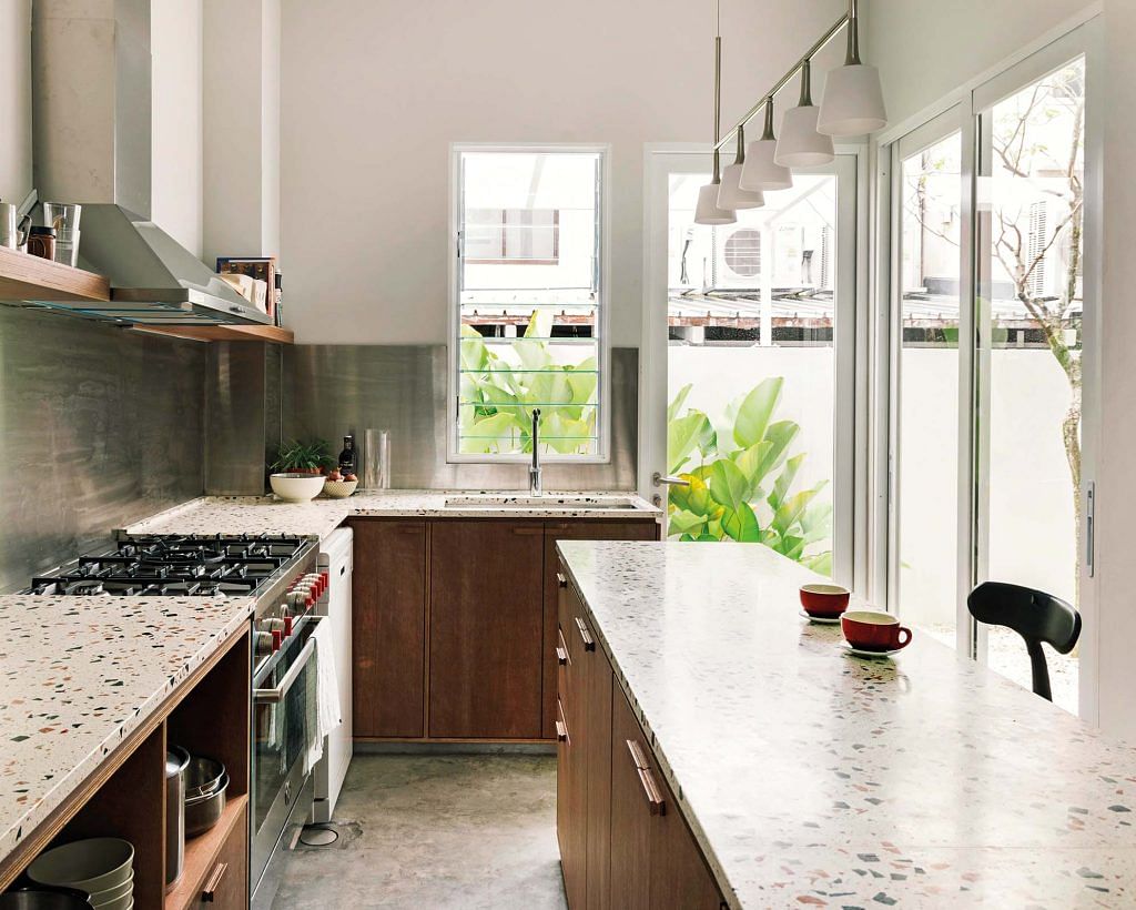 The bare marine ply, natural terrazzo counters and stainless steel backsplash all pay homage to mid-century living.