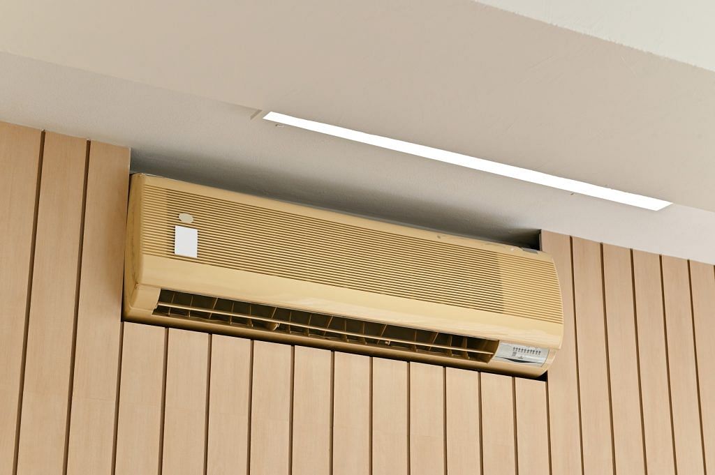Aircon set in a brown partition wall to hide unsightly aircon trunking