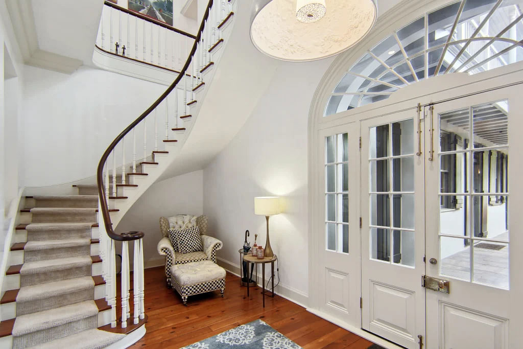 The three-story guest house includes a beautiful staircase.