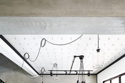 The utilitarian order of hooks prevents the ceiling from looking too overwhelming.