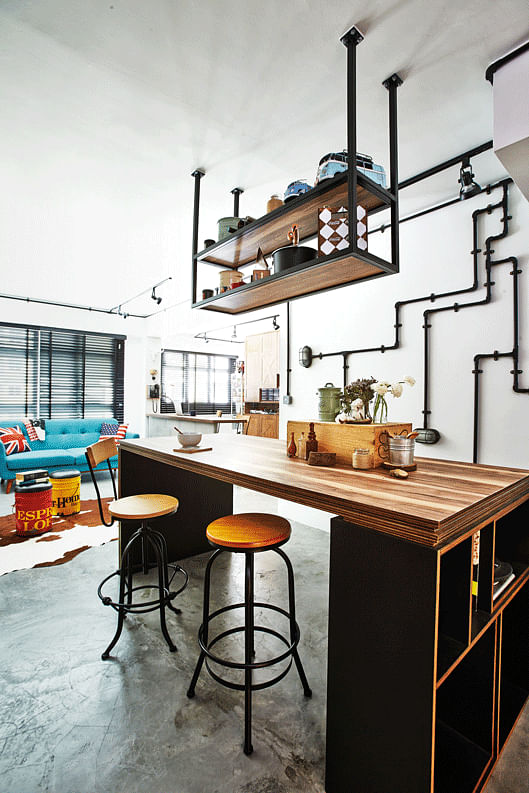 [Renovation cost: $45,000] To complement the industrial look of the home, the dining table was built to look like a workshop table, and is paired with bar stools instead of dining chairs.