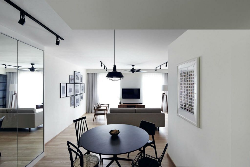 Each chair around the dining table has a different design, but the open-concept dining area still looks uniformed thanks to the consistent use of black.