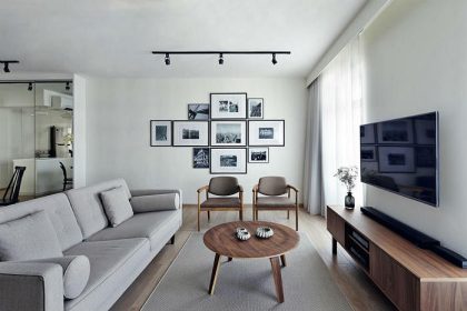 A geometric arrangement of photographs taken by the couple form a focal point in the living area. Candle plates on coffee table, from stylodeco.com.