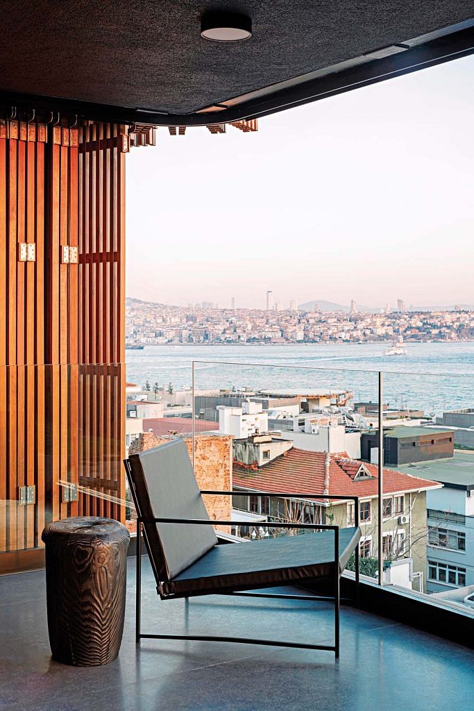 Balcony with a chair overlooking the city