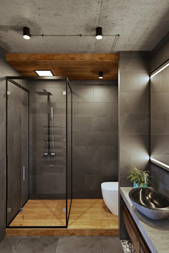 Natural materials like wood and stone, as well as accessories like pebbles, create a spa-like atmosphere in the bathroom.