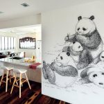 Interior design firm Mint Studio gave this HDB maisonette a clean and calm feel with its white palette and warm wood flooring and a wall mural of giant pandas.
