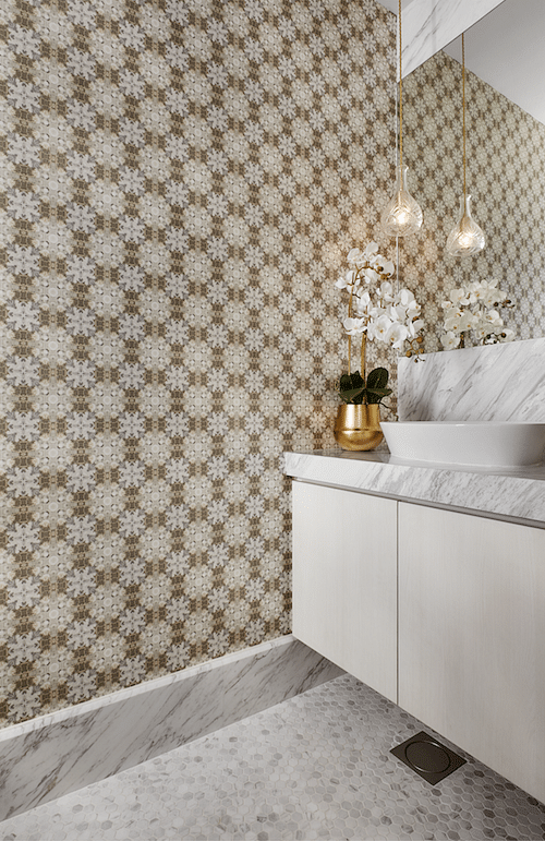 In the powder room, the design team matched patterned wallcoverings with gold fittings, marble walls and Volakas hexagonal mosaic floor tiles.