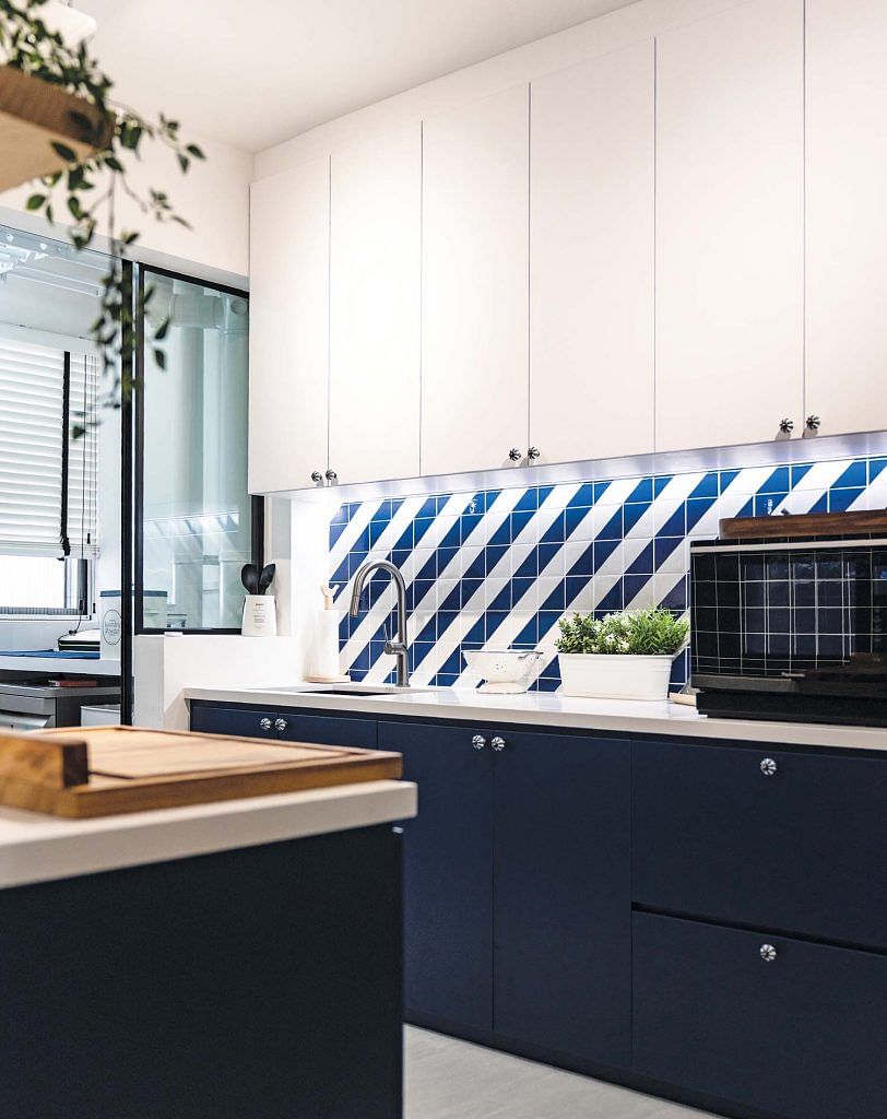 The kitchen is an energising space with dark blue and white surfaces interspersed with patterns.