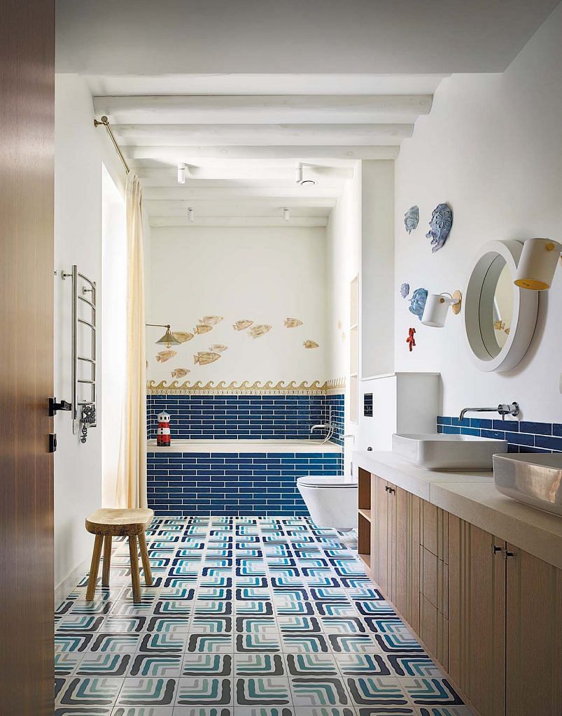 The children’s bathroom features whimsical marine and coastal elements while keeping the look timeless.