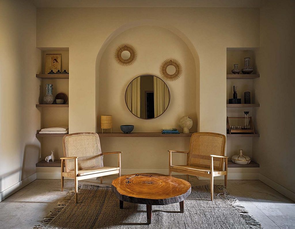 An arched niche, timber coffee table, woven cane and rug create a layered texture.