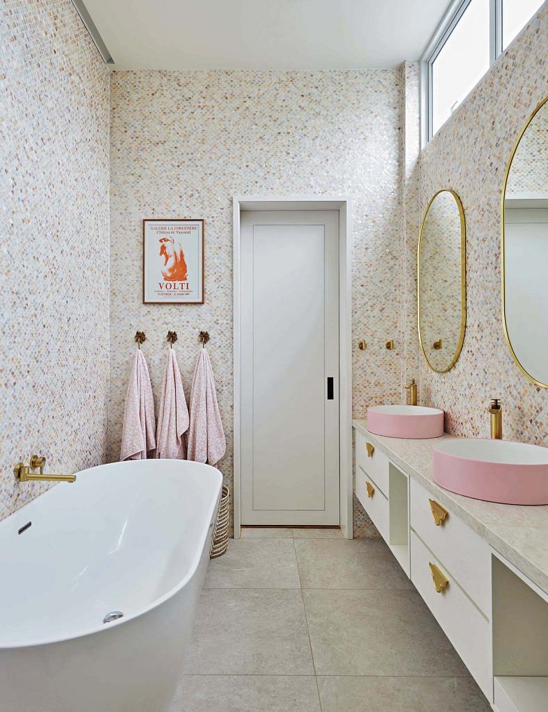 The luminous sheen from the mother-of-pearl mosaics in the girls’ bathroom lend a dreamy vibe to an otherwise utilitarian space.