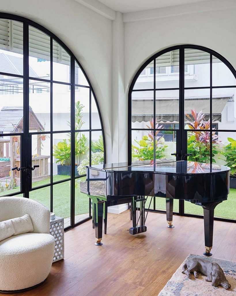 New Crittall-style arched doors and panels around the living room fill the space with abundant natural light.