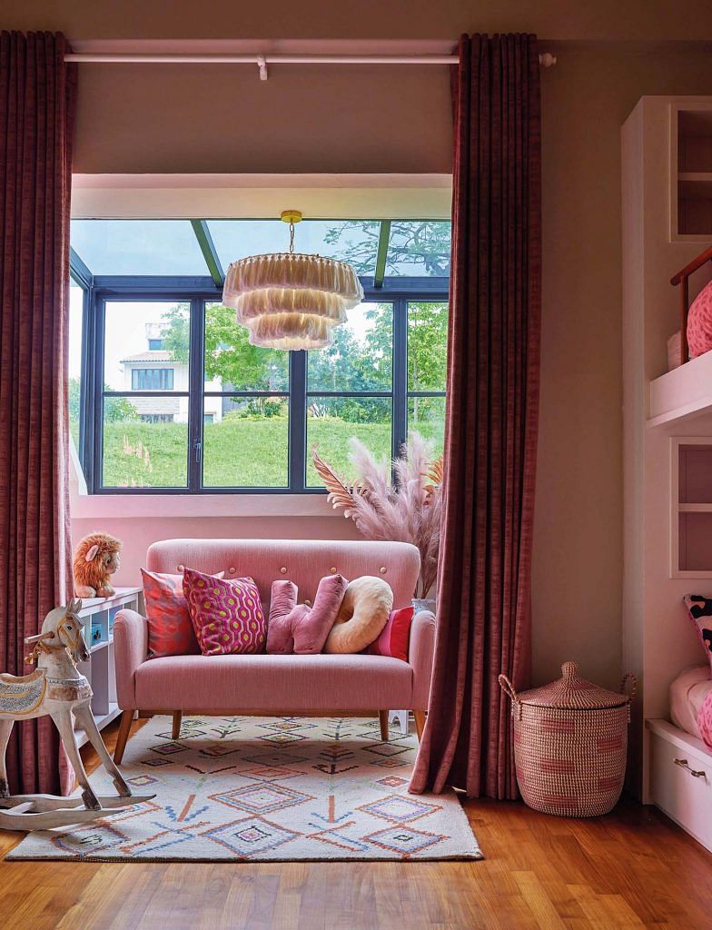 Tall, velvety curtains not only serve a practical purpose as sunshade, but also mimic theatre curtains that transform this corner in the girls’ bedroom into a little performance area.