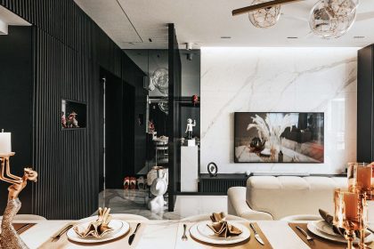 Marble TV wall and black and gold accents contribute to a modern luxury look
