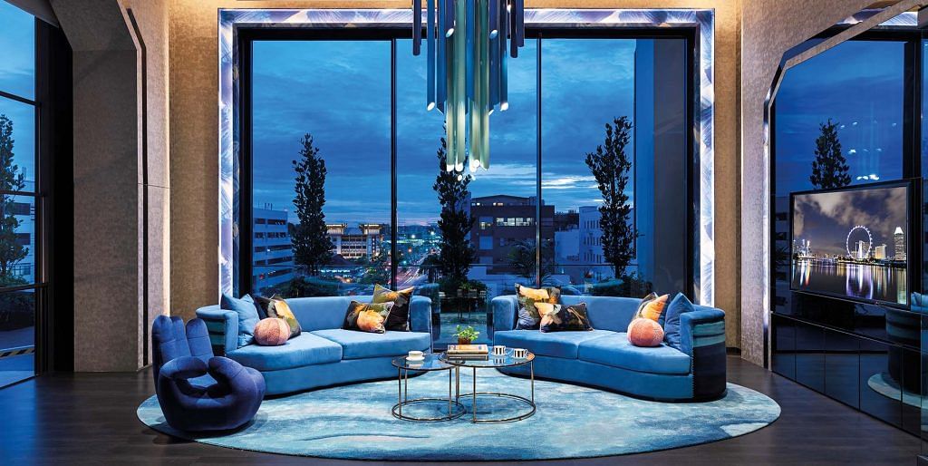 A spacious lounge furnished with plush sofa in a blue hue to foster an inviting atmosphere at the Sapphire Windows showroom.