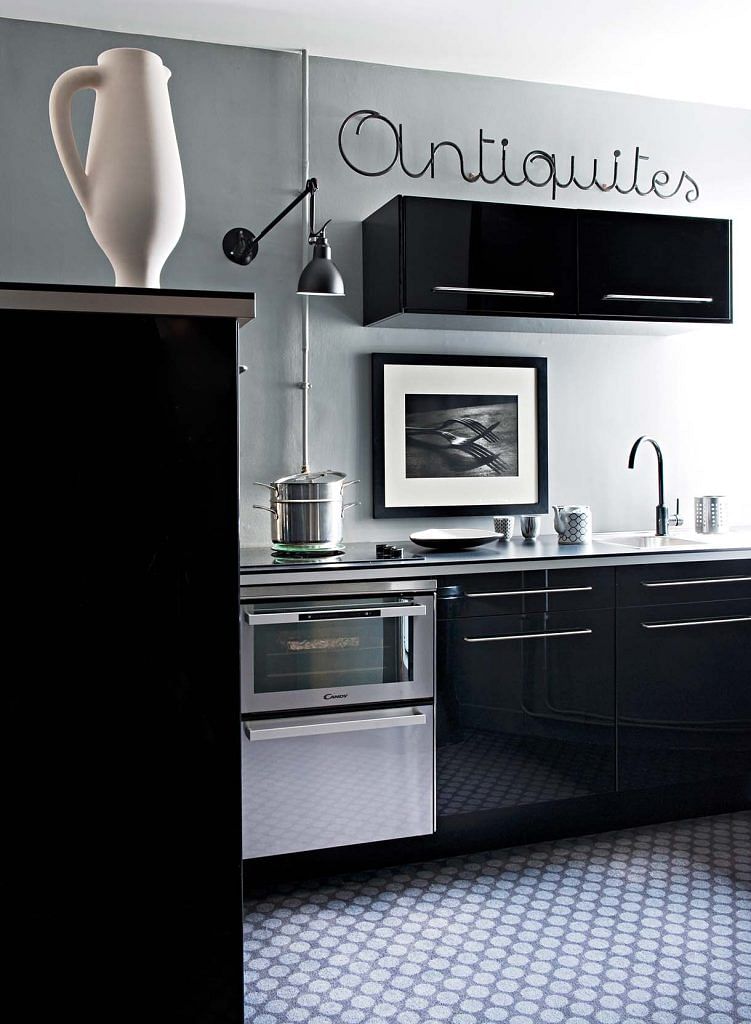 The black and white kitchen contrasts dramatically with the rest of the home.