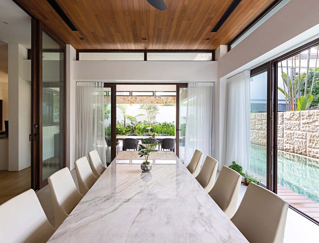 The dining area is more private and enclosed according to the homeowners’ preference, with a view of, and access to the swimming pool and alfresco areas.