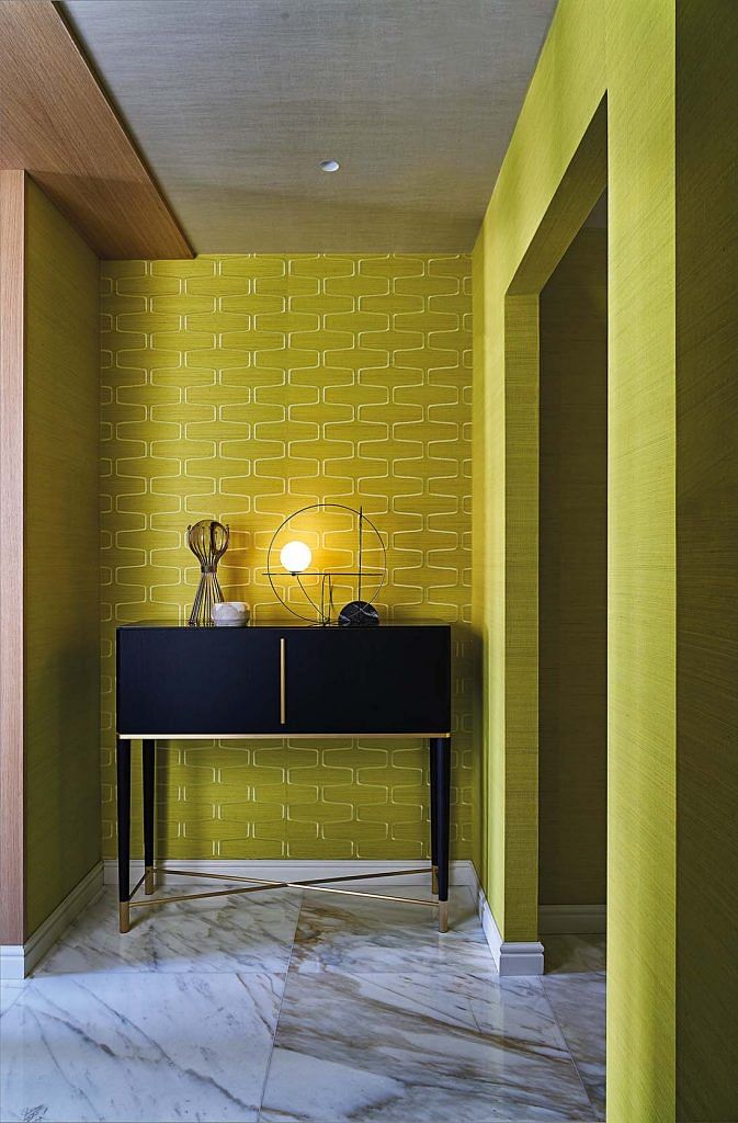 The yellow palette in the entryway creates a warm and inviting atmosphere.