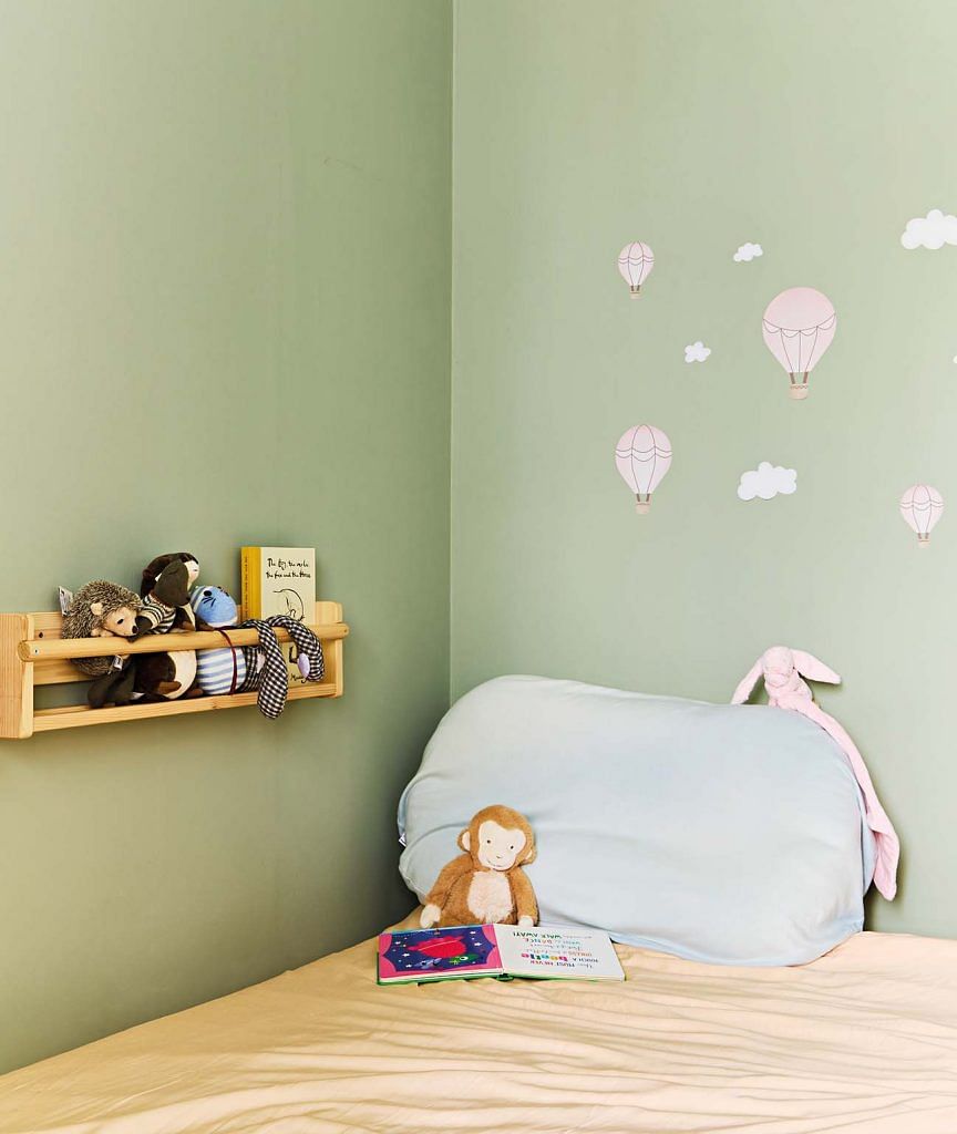 The green coloured walls in the baby’s room relate to the green kitchen cabinets and reflect the homeowners’ preference for nature-inspired colours.