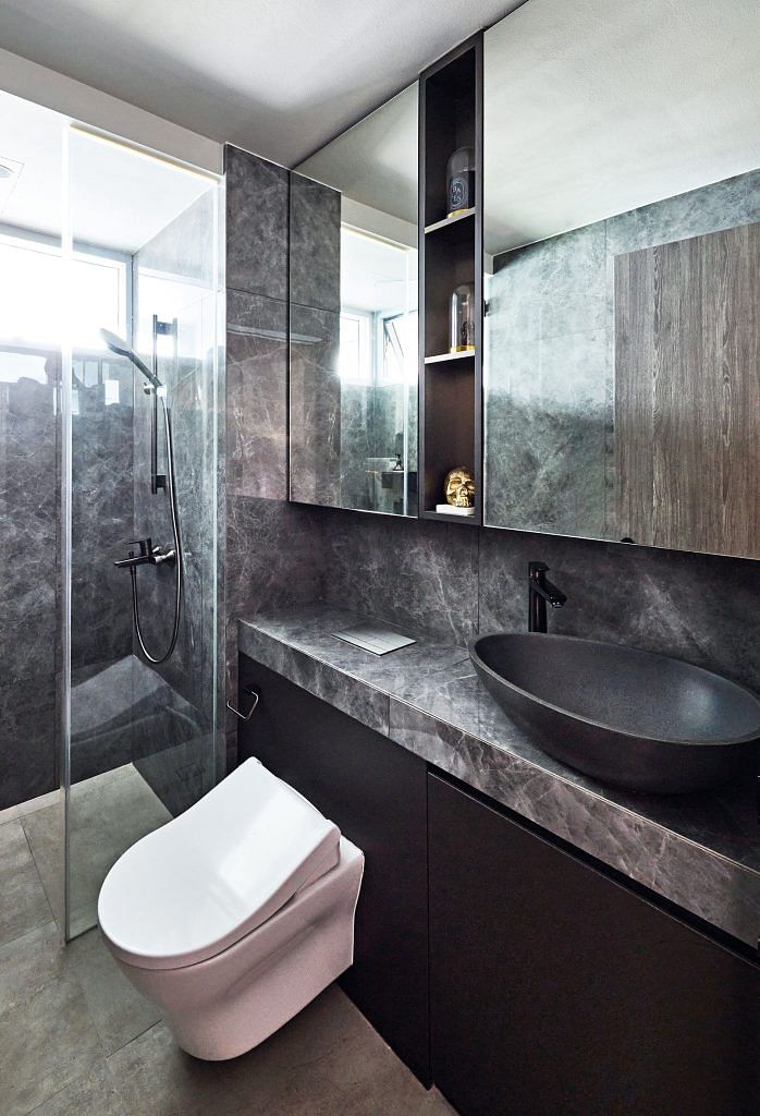 The common bathroom reflects a similar colour palette as the master bathroom.