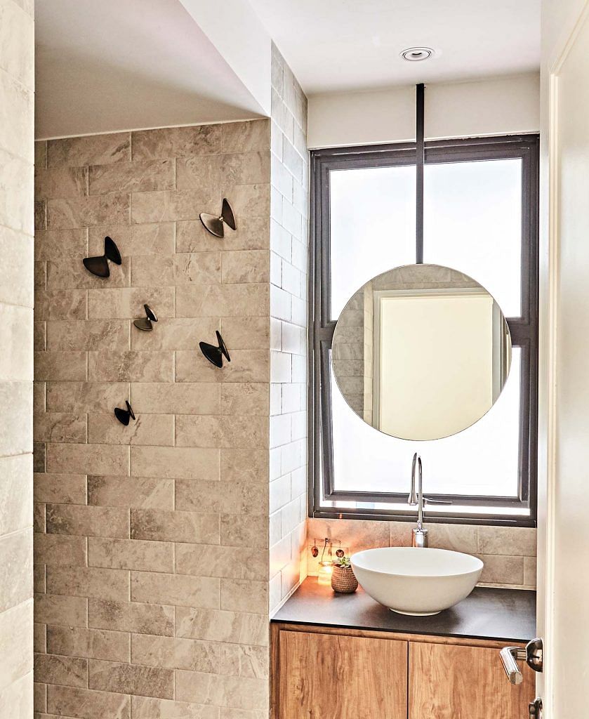 The butterfly-shaped wall hooks in the common bathroom double as wall art.