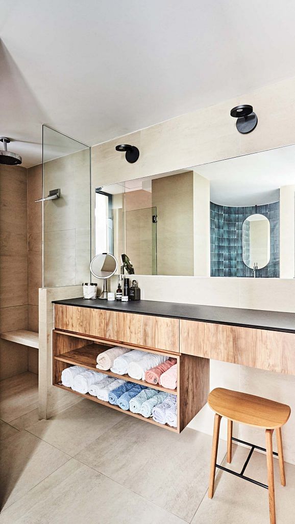 The enlarged master bathroom features floating cabinetry.