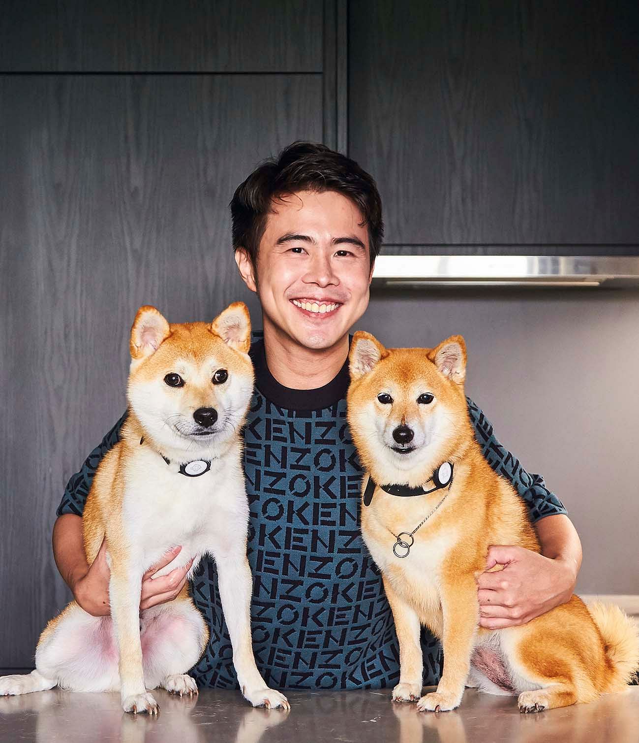 The 36-year-old entrepreneur, Clive Choo, in his 2-bedroom condominium in Siglap, pictured with his two dogs, Miwa and Yoshi