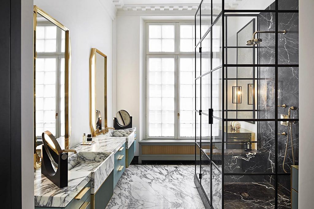 Arbescato marble lends a regal air to the bathroom.
