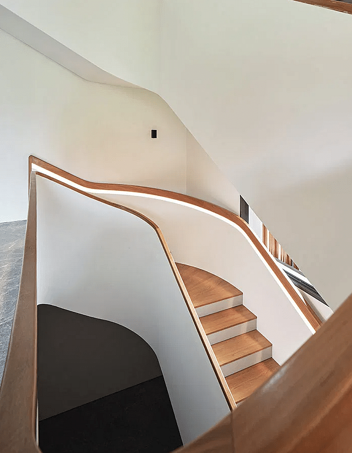 Also sculptural, the main staircase connects three floors in a serpentine sweep. (Photo: Fabian Ong)