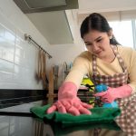 Domestic helper cleaning the kitchen