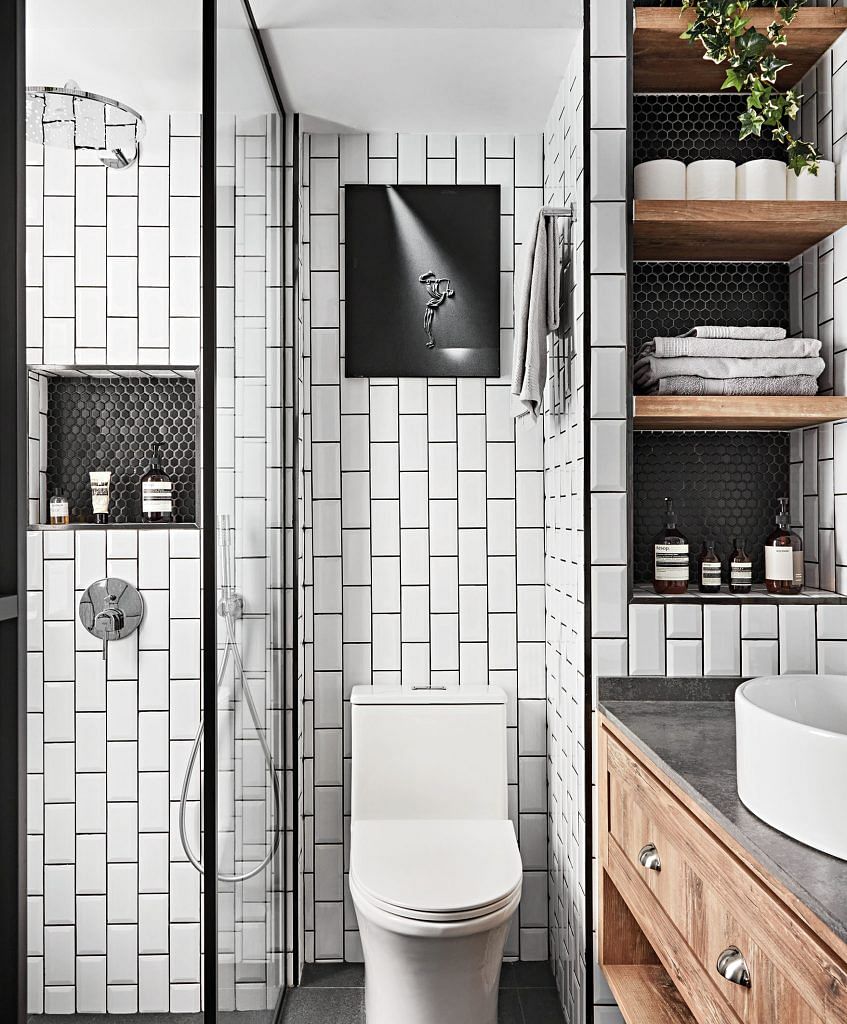Aligning the tiles vertically gives a fresh spin to subway tiles. The bathroom feels neat and organised due to the niches in the shower and vanity areas.