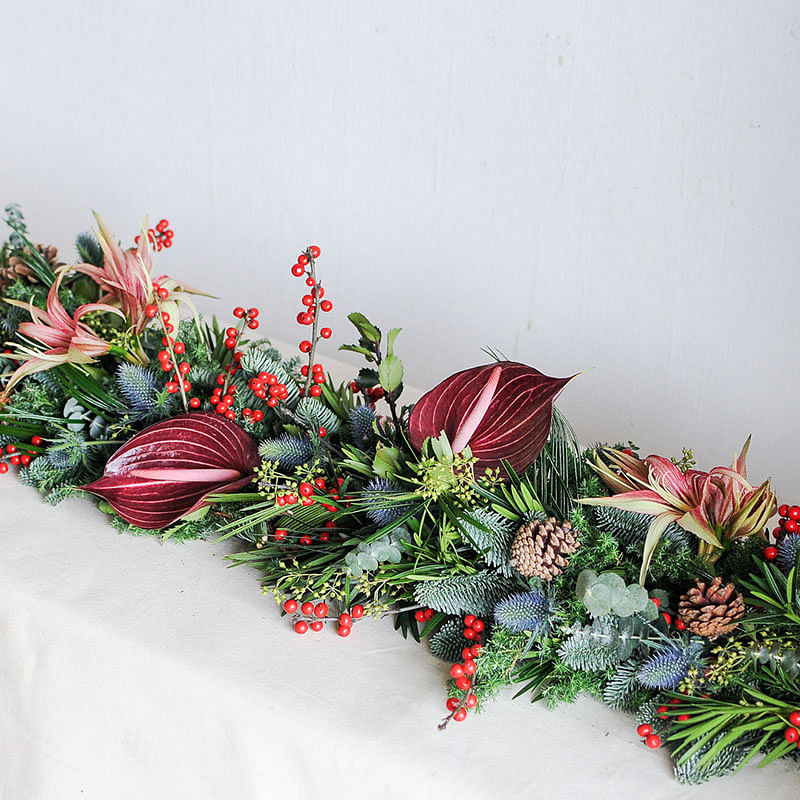 Wonderland Botanicals Christmas Table Runner flower arrangement is priced from $250 to $360