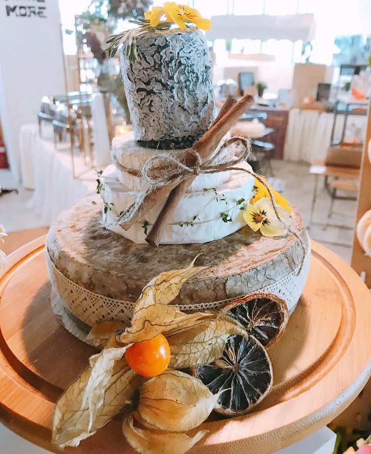 Stack cheese vertically to create a "cake" of cheese on your charcuterie grazing table. Image: Kiss My Pans