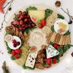 Grazing table and board ideas for Christmas. Christmas wreath-shaped cheese charcuterie grazing table. Image from Lush Platters