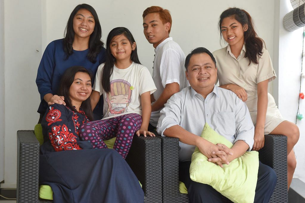 School teacher Norharyati Hassan and Nahar Azmi Abdul Majid with their children (from left) Sarah Nahar Azmi, 14; Zahra Nahar Azmi, eight; Faris Nahar Azmi, 19, and Nadhrah Nahar Azmi, 17. Mr Nahar bought their terrace house in Opera Estate in 2009 for about $1.25 million. ST PHOTO: FELINE LIM