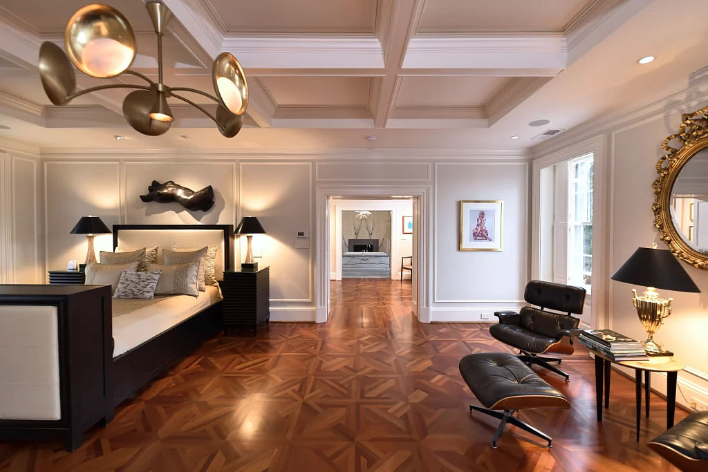 The spacious primary suite features parquet flooring.