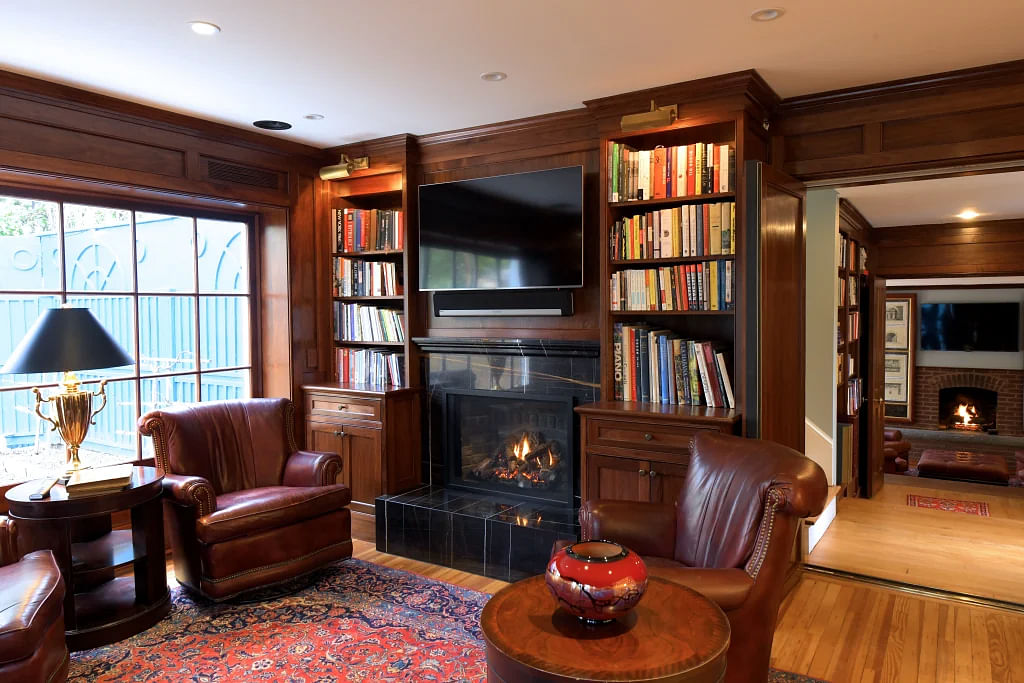 The wood-paneled study features an original fireplace.