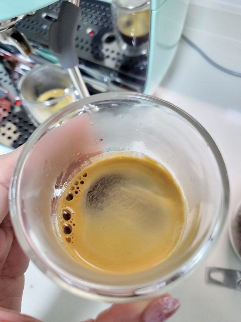 Crema in a cup of double shot espresso made from the new 2023 SMEG espresso coffee machine with integrated grinder EGF03