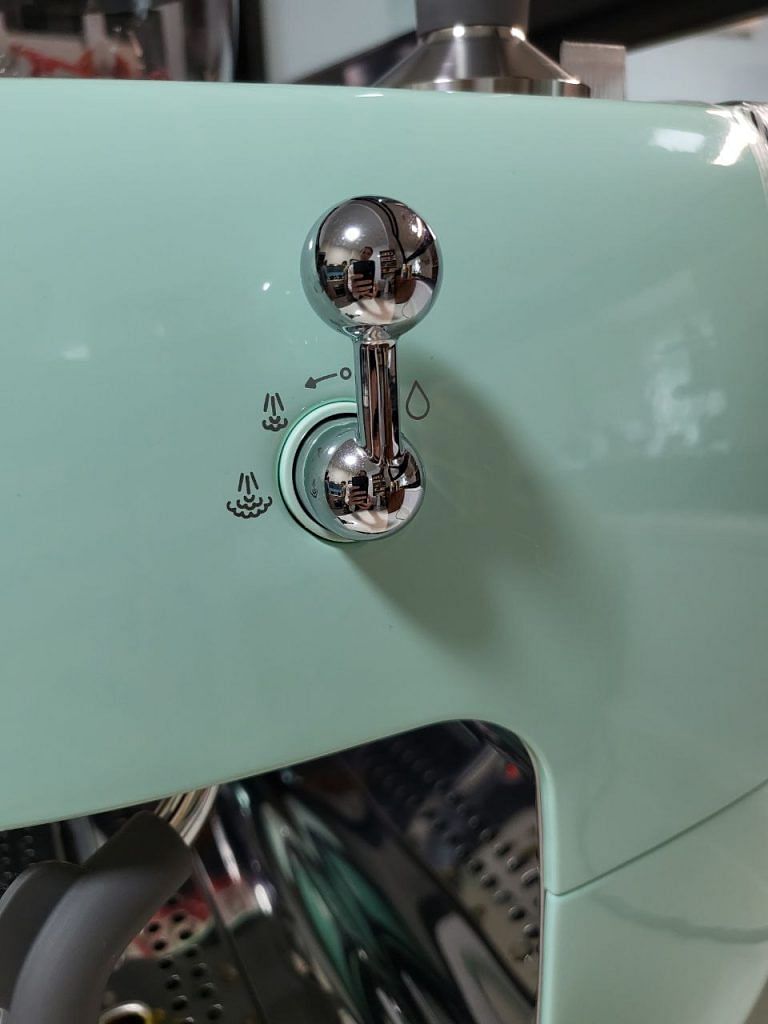 Milk steamer valve on the right side of the SMEG espresso coffee machine with integrated grinder EGF03