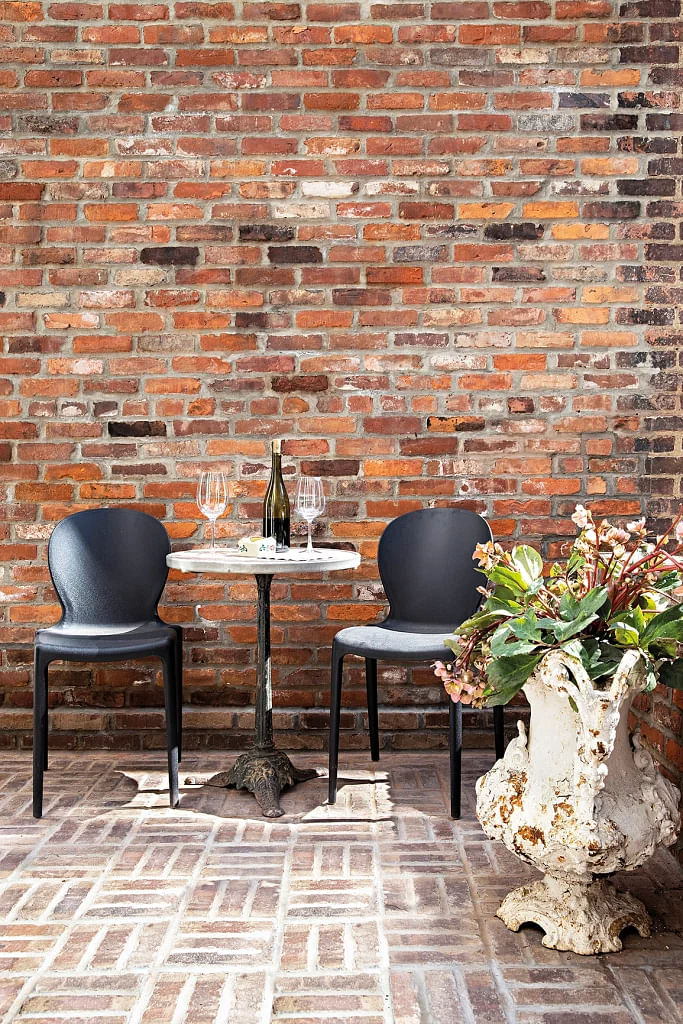 The brick wall in this corner was left bare to juxtapose with the white walls.